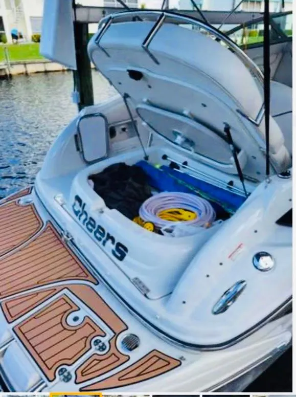 Slide: The Image of 2007 Crownline 270 CR boat with open storage, docked by the water. - 10