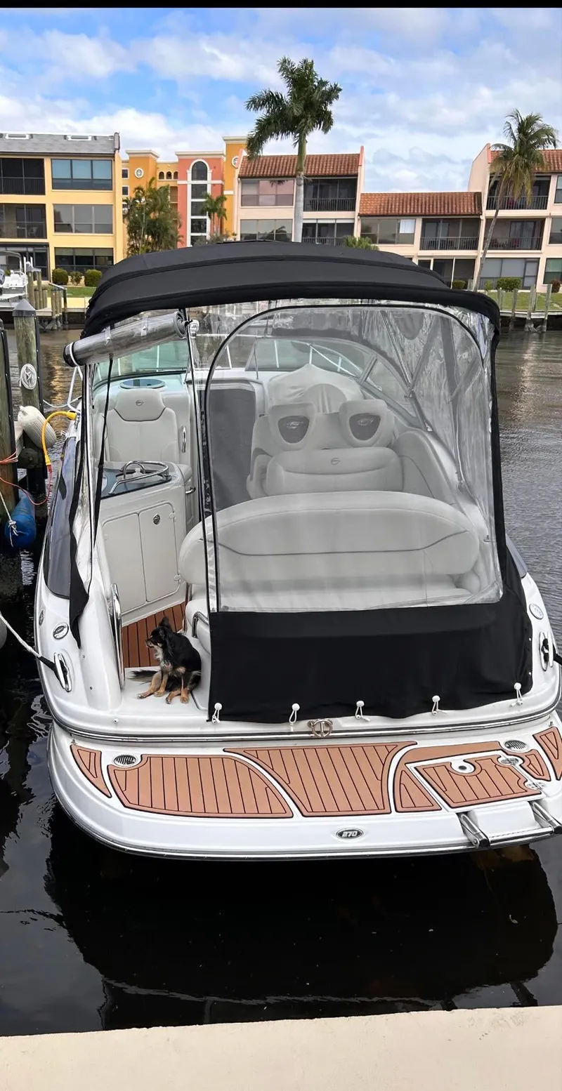 Slide: The Image of 2007 Crownline 270 CR boat docked, featuring a black canopy and wooden deck accents. - 3