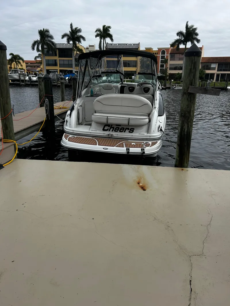 Slide: The Image of 2007 Crownline 270 CR boat docked at marina with palm trees in background. - 4