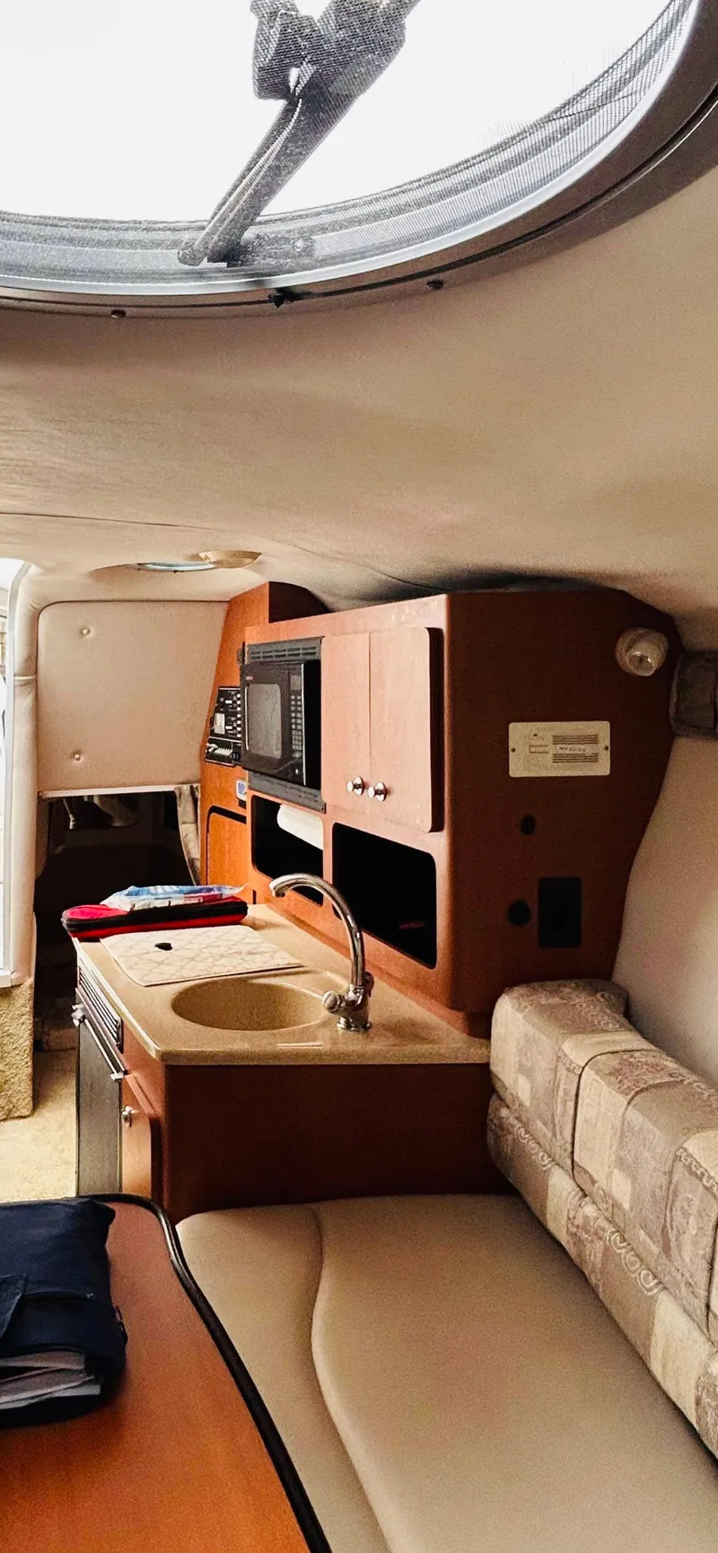 Slide: The Image of Interior of 2007 Crownline 270 CR boat with kitchenette and seating area. - 7