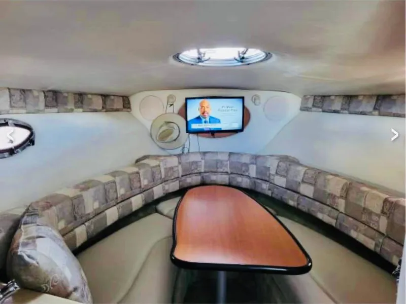 Slide: The Image of Interior of 2007 Crownline 270 CR boat with cozy seating and mounted TV. - 8