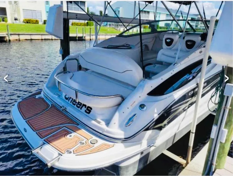 Slide: The Image of 2007 Crownline 270 CR boat docked, featuring spacious seating and sleek design. - 9