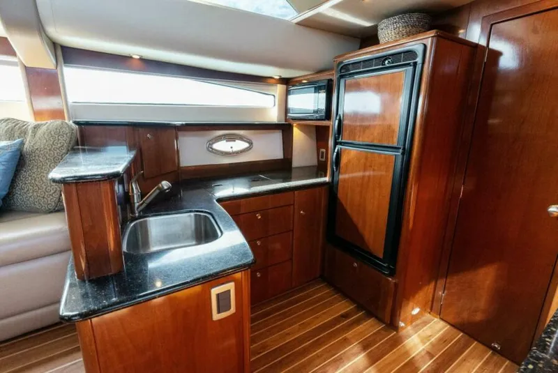 Slide: The Image of Luxurious kitchen interior of 2008 Meridian 459 Motoryacht with wood cabinetry and modern appliances. - 11
