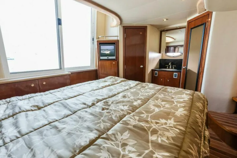 Slide: The Image of Interior of 2008 Meridian 459 Motoryacht bedroom with bed, window, and ensuite bathroom. - 16