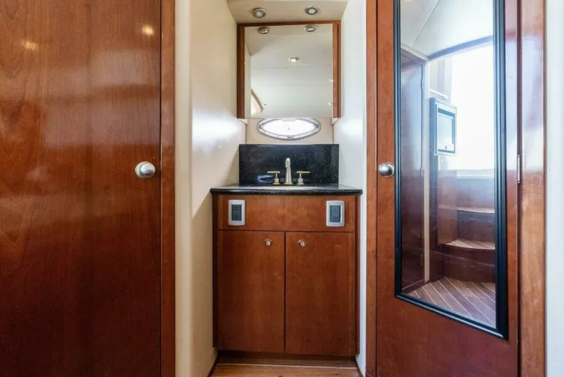 Slide: The Image of 2008 Meridian 459 Motoryacht bathroom with wood cabinetry and modern fixtures. - 18