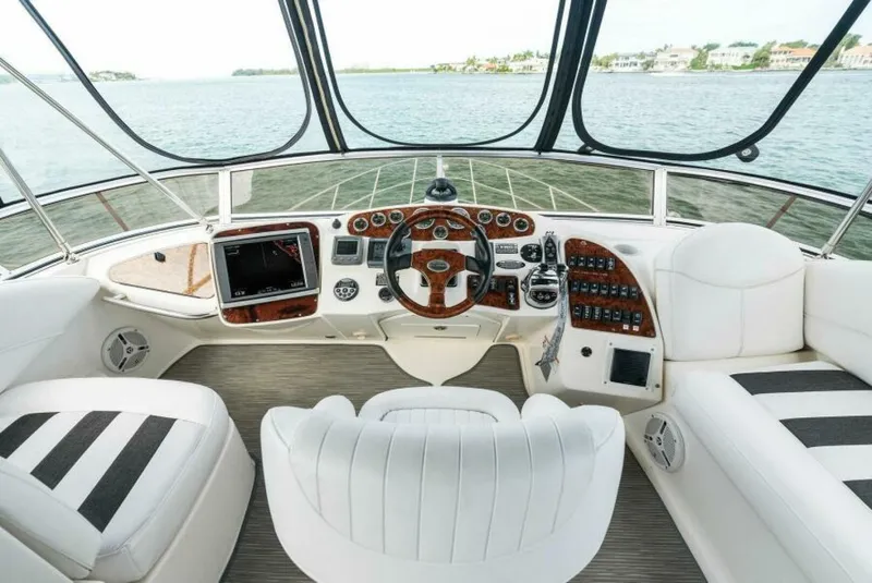 Slide: The Image of 2008 Meridian 459 Motoryacht helm with luxurious white seating and advanced navigation controls. - 2