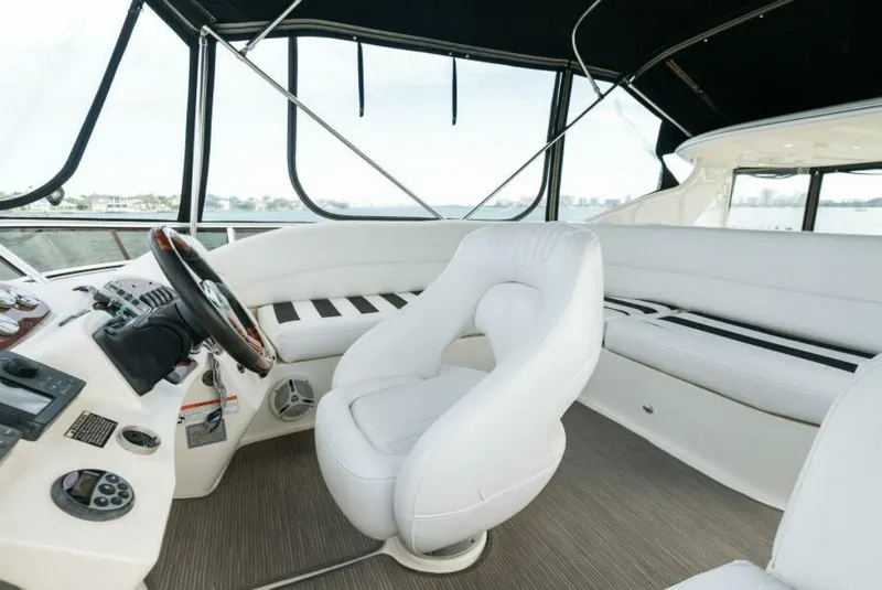 Slide: The Image of 2008 Meridian 459 Motoryacht helm with white seating and panoramic windows. - 22