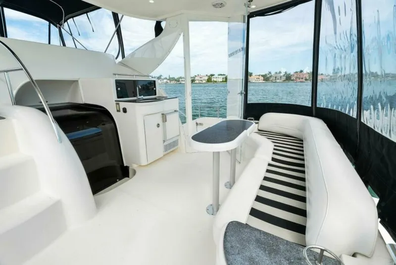Slide: The Image of 2008 Meridian 459 Motoryacht interior with seating, table, and water view. - 23