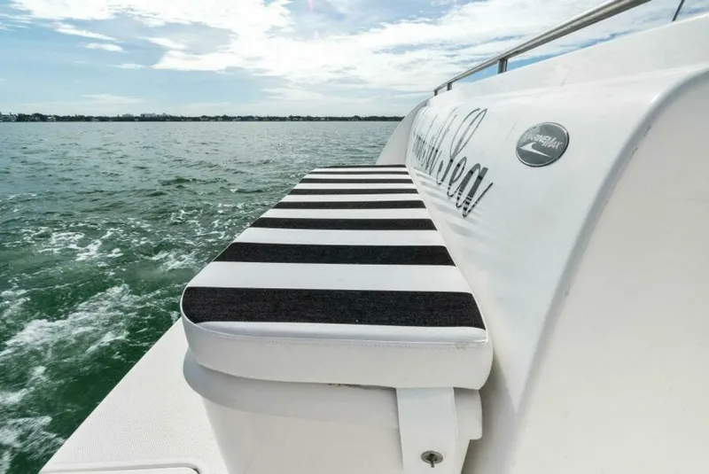 Slide: The Image of 2008 Meridian 459 Motoryacht with striped seating, cruising on open water. - 28