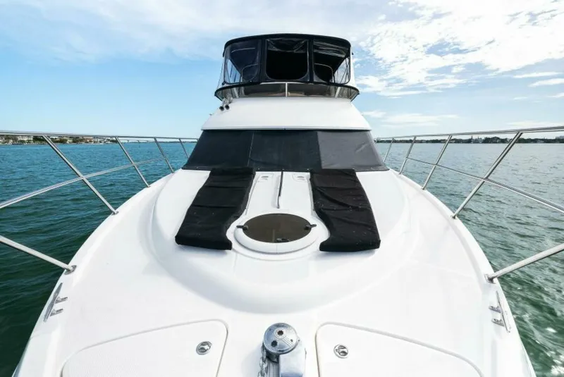 Slide: The Image of 2008 Meridian 459 Motoryacht on calm water, featuring spacious deck and sleek design. - 3