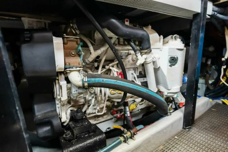 Slide: The Image of Engine compartment of a 2008 Meridian 459 Motoryacht, showcasing mechanical components and hoses. - 30
