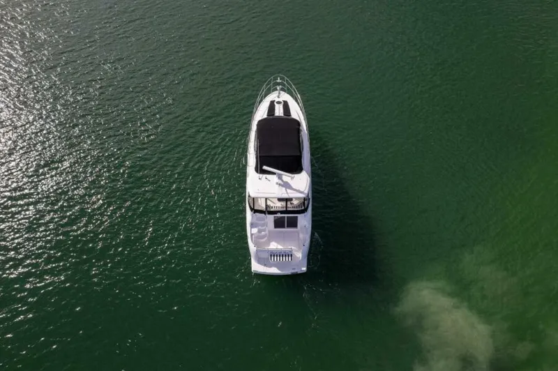 Slide: The Image of 2008 Meridian 459 Motoryacht cruising on calm green waters, aerial view. - 32
