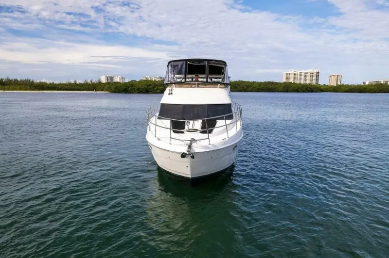 Slide: The Image of 2008 Meridian 459 Motoryacht on calm water with cityscape background. - 33