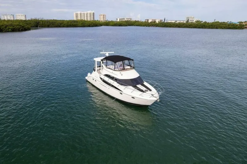 Slide: The Image of 2008 Meridian 459 Motoryacht on calm water with cityscape in background. - 35