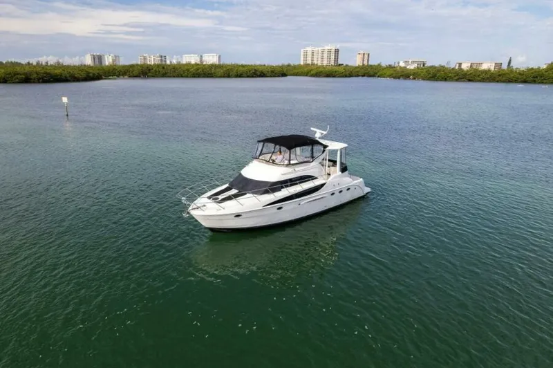 Slide: The Image of 2008 Meridian 459 Motoryacht on calm water with cityscape background. - 36