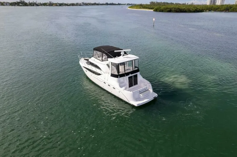 Slide: The Image of 2008 Meridian 459 Motoryacht cruising on calm waters, featuring sleek design and spacious deck. - 38