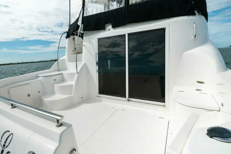 Slide: The Image of 2008 Meridian 459 Motoryacht deck with sliding glass doors and ocean view. - 4