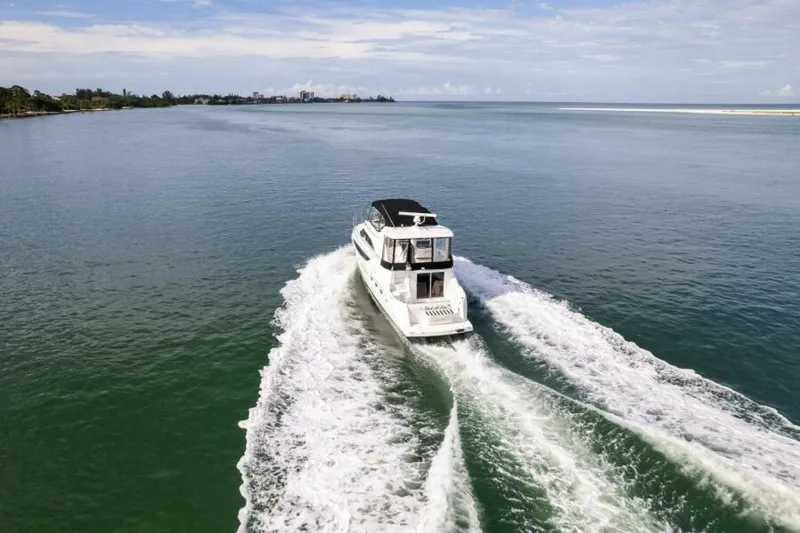 Slide: The Image of 2008 Meridian 459 Motoryacht cruising on open water, leaving a wake behind. - 41