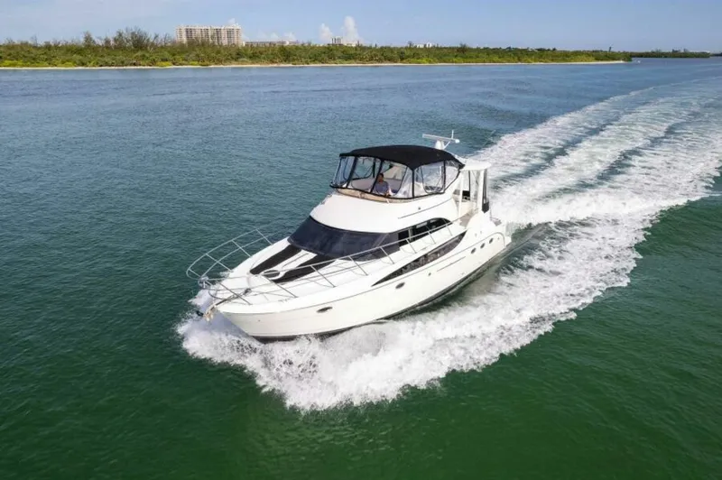 Slide: The Image of 2008 Meridian 459 Motoryacht cruising on open water, creating a wake. - 42