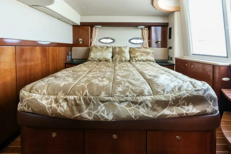 Slide: The Image of Luxurious bedroom interior of 2008 Meridian 459 Motoryacht with elegant bedding and wood paneling. - 5