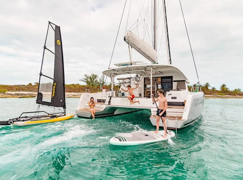 The Image of People enjoying water activities near a 2017 Lagoon 42 catamaran. - 0