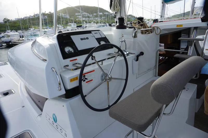 Slide: The Image of Helm of 2017 Lagoon 42 catamaran with steering wheel and navigation instruments. - 2
