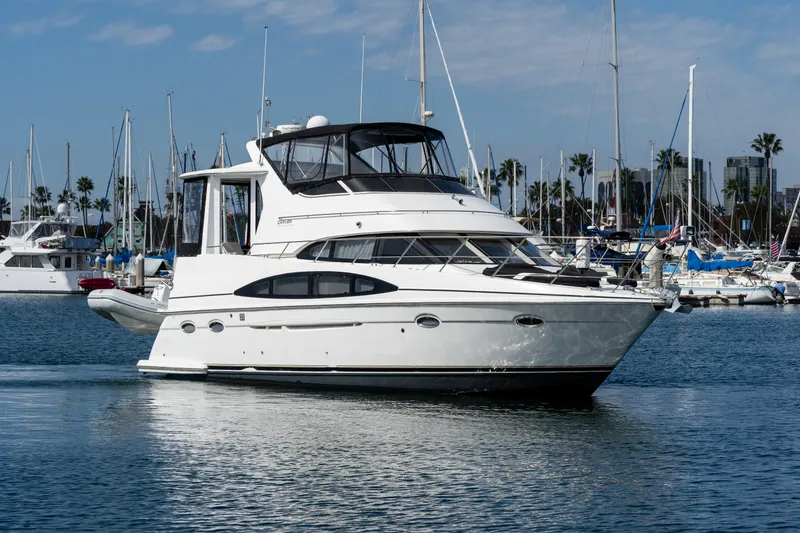 The Image of 2001 Carver 396 Motor Yacht on calm harbor waters. - 0
