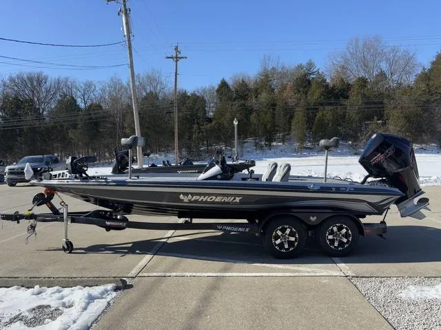 Slide: The Image of 2025 Phoenix 721 ZXL boat on trailer, parked outdoors in winter setting. - 12