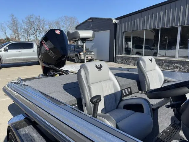 Slide: The Image of 2025 Phoenix 721 ZXL boat with sleek design and comfortable seating, parked outdoors. - 5