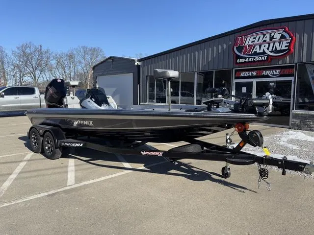 Slide: The Image of 2025 Phoenix 721 ZXL boat parked outside dealership, sunny day, clear sky. - 6