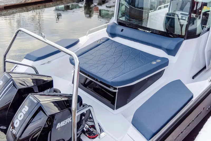 Slide: The Image of 2025 Axopar 29 XC Cross Cabin boat with dual Mercury engines, docked at marina. - 11