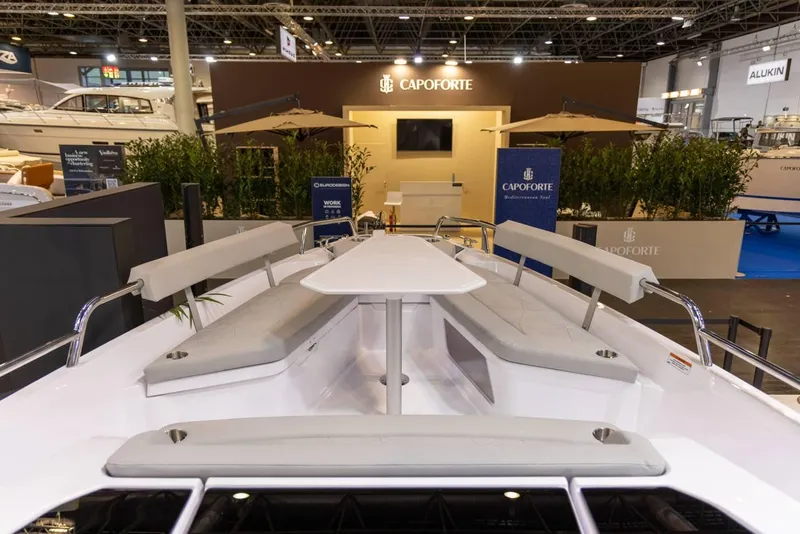 Slide: The Image of 2025 Axopar 29 XC Cross Cabin at Capoforte exhibit, showcasing sleek design and seating. - 12