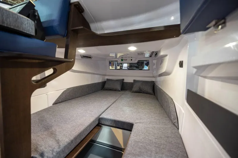 Slide: The Image of 2025 Axopar 29 XC Cross Cabin interior with cozy sleeping area and modern design. - 13