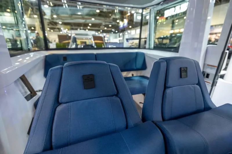 Slide: The Image of 2025 Axopar 29 XC Cross Cabin interior with blue seating and modern design. - 6