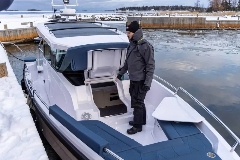 Slide: The Image of 2025 Axopar 29 XC Cross Cabin in snowy dock setting. - 9