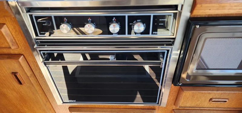 Slide: The Image of Built-in oven and microwave in a 1985 Bertram 33 Flybridge Cruiser kitchen. - 17
