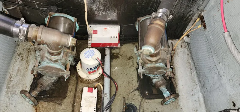 Slide: The Image of Engine room of a 1985 Bertram 33 Flybridge Cruiser showing mechanical components and wiring. - 26