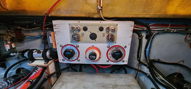 Slide: The Image of Electrical panel of a 1985 Bertram 33 Flybridge Cruiser with wiring and controls. - 36