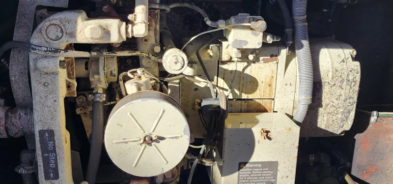 Slide: The Image of Engine components of a 1985 Bertram 33 Flybridge Cruiser in close-up view. - 37