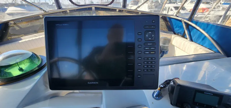 Slide: The Image of Garmin marine electronics on 1985 Bertram 33 Flybridge Cruiser dashboard. - 4