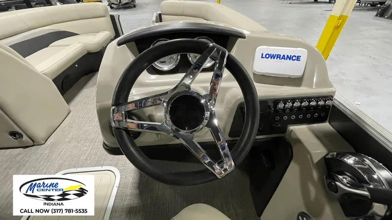Slide: The Image of 2020 Barletta C22QC boat dashboard with steering wheel and Lowrance display. - 12