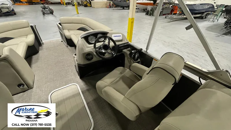 Slide: The Image of 2020 Barletta C22QC pontoon boat interior with beige seating and steering console. - 14