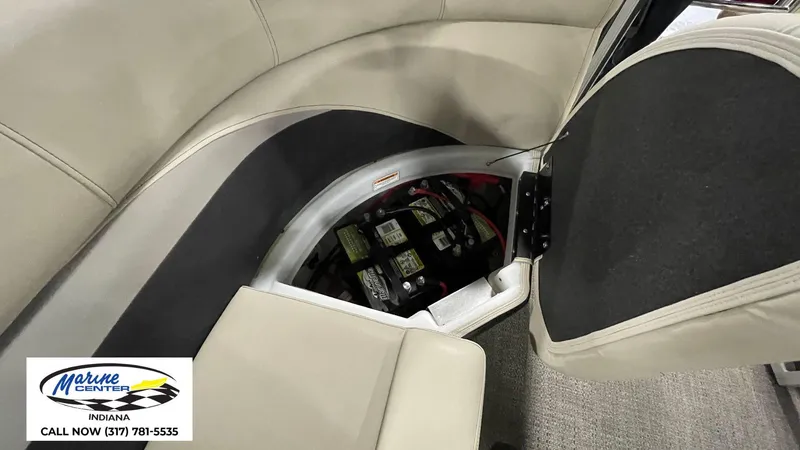 Slide: The Image of 2020 Barletta C22QC boat battery compartment with seating, Marine Center contact info visible. - 9