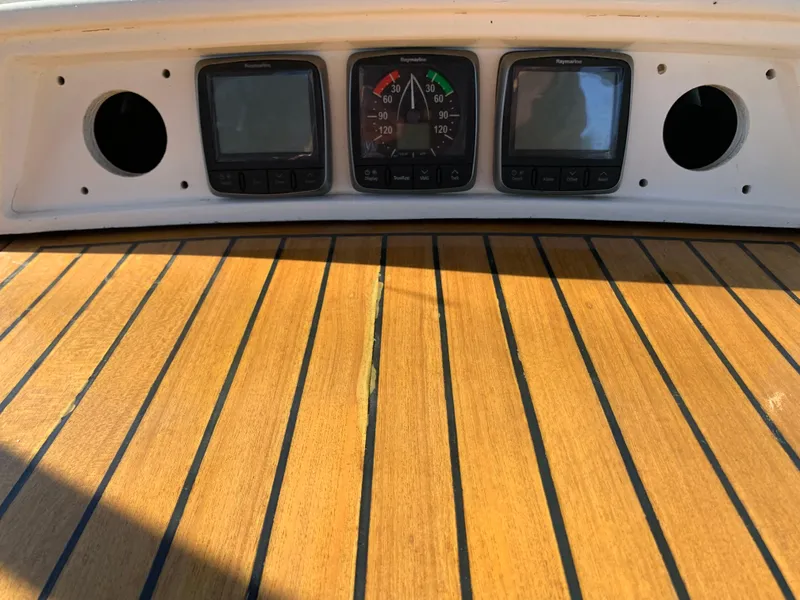 Slide: The Image of 1983 Liberty Center Cockpit dashboard with gauges and wooden paneling. - 11