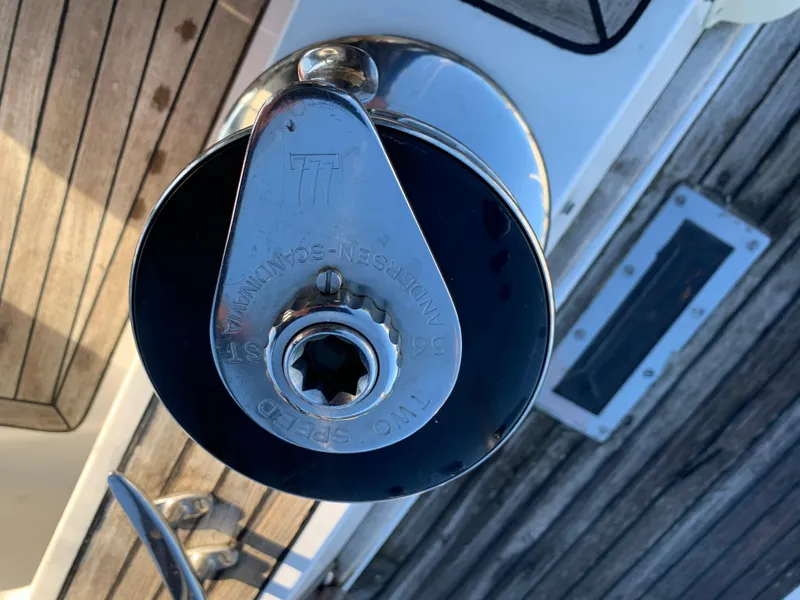Slide: The Image of Winch mechanism on 1983 Liberty Center Cockpit sailboat deck, featuring wooden and metal elements. - 14
