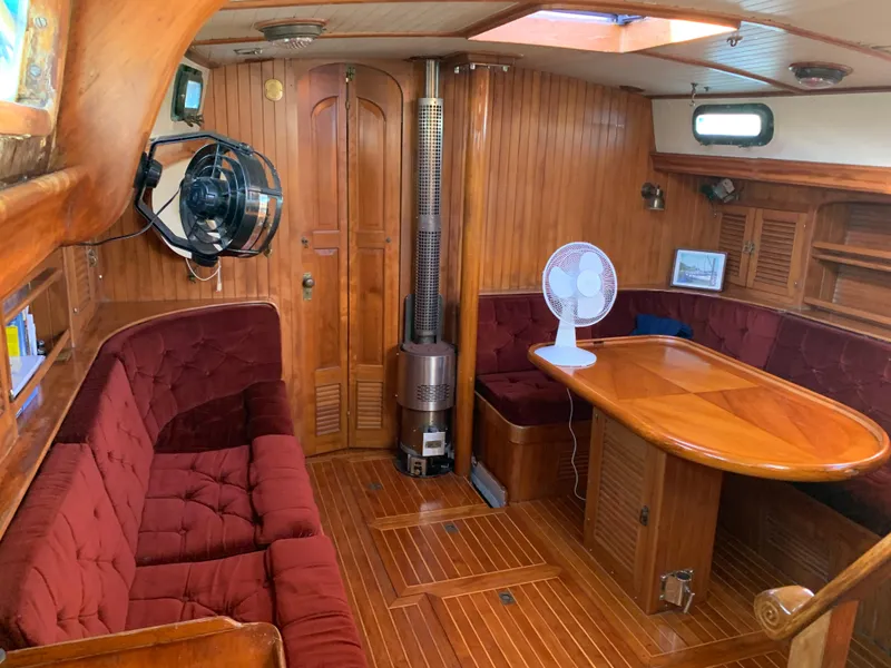 Slide: The Image of 1983 Liberty Center Cockpit interior with wood paneling, red seating, and dining table. - 17