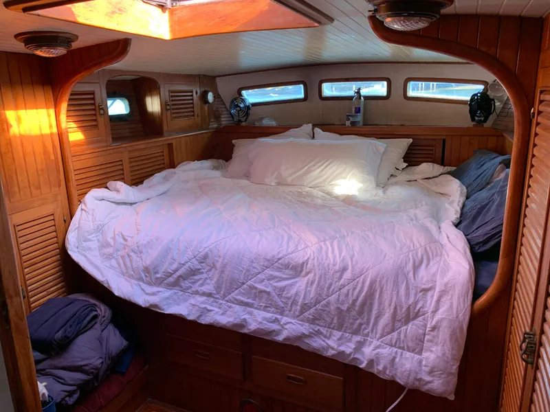 Slide: The Image of Cozy cabin interior of 1983 Liberty Center Cockpit with a comfortable bed and wooden paneling. - 19