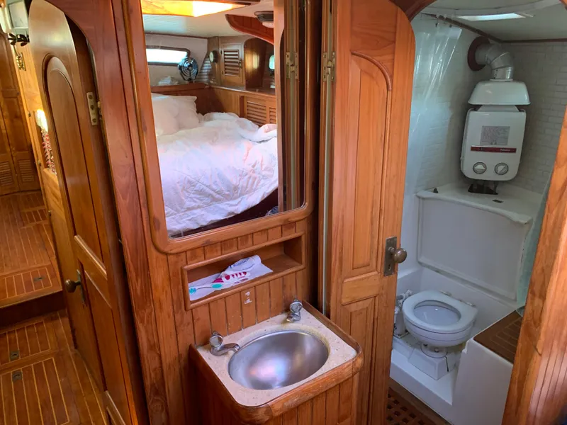Slide: The Image of 1983 Liberty Center Cockpit interior with wooden finish, sink, and compact bathroom. - 20