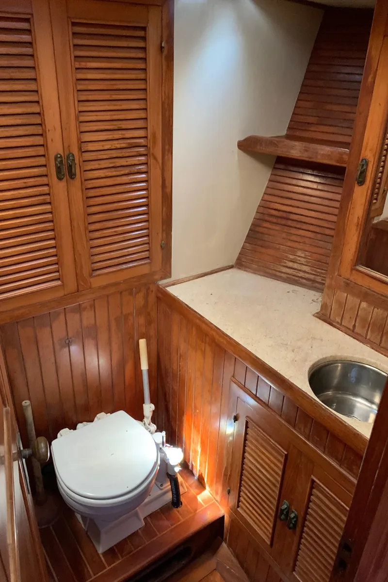 Slide: The Image of 1983 Liberty Center Cockpit bathroom with wooden cabinetry and compact design. - 22
