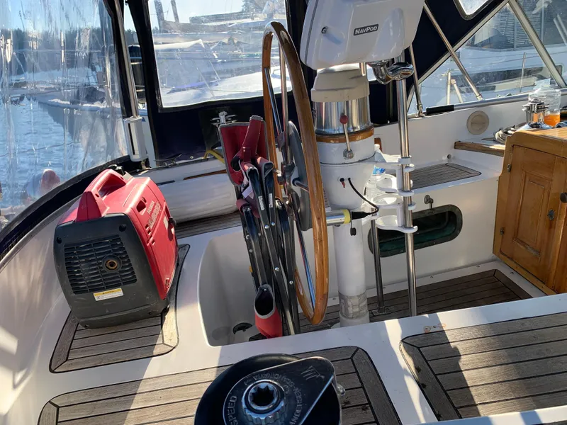 Slide: The Image of 1983 Liberty Center Cockpit with steering wheel, generator, and nautical equipment. - 4